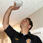 Fire Rescue staff checking smoke alarm