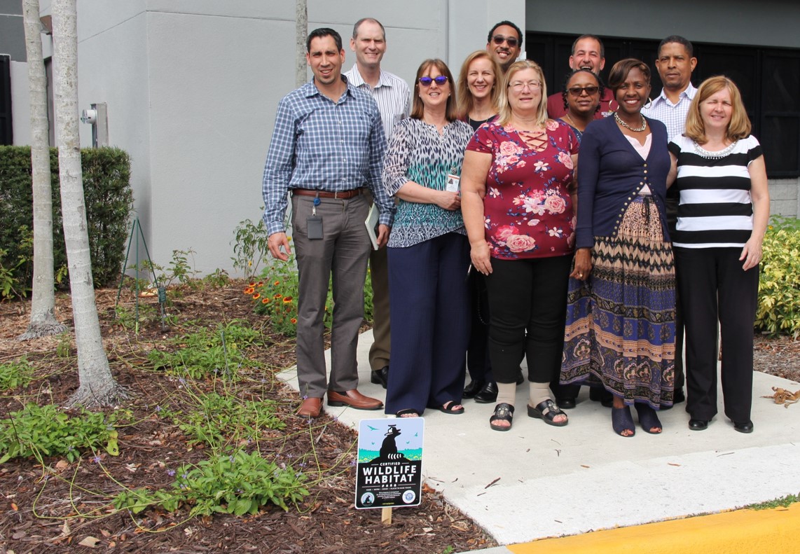 Utilities Staff pose by the new butterfly garden and certified habitat at the Utilities Administrative Center