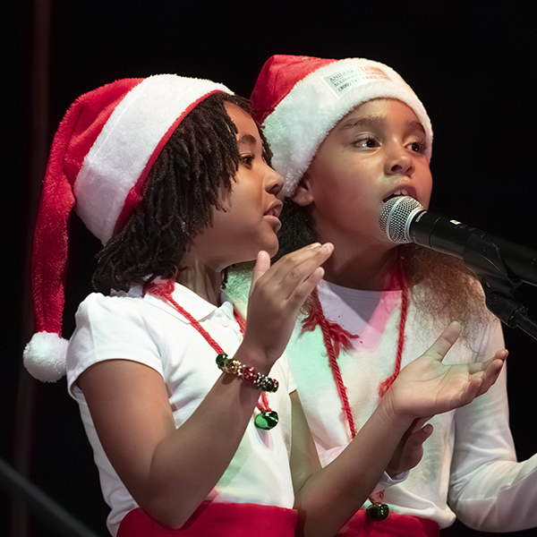 Children singing at holiday event